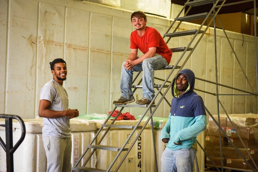 The White Oak Pastures order fulfillment staff takes break to pose for a photo