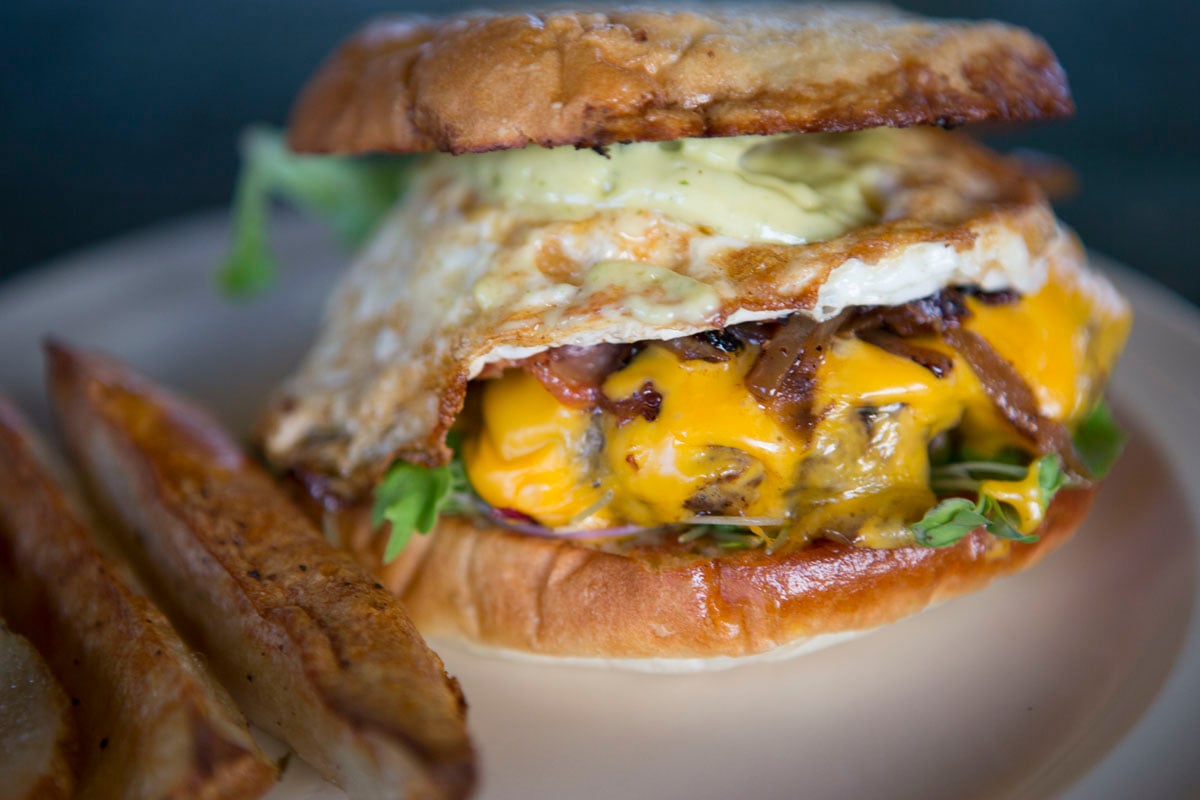 Farmer John Burger is a stable menu item in our farm to table dining pavilion using our pasture raised eggs certified organic vegetables and pasture raised bacon and pasture raised grass-fed ground beef