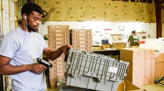 Deion Wallace scans inventory control codes at White Oak Pastures