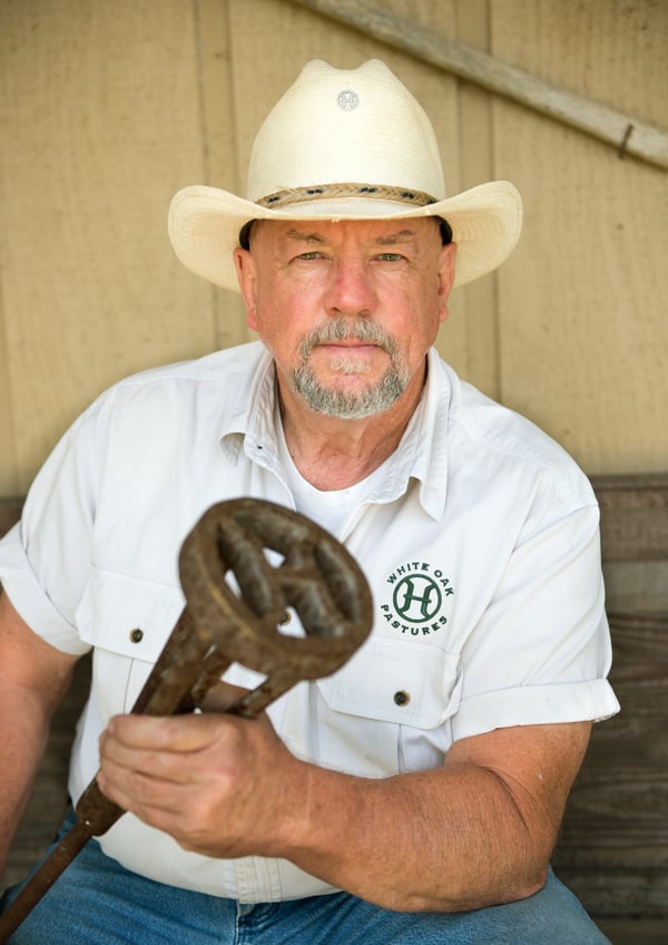 Will Harris holds the White Oak Pastures heritage branding iron