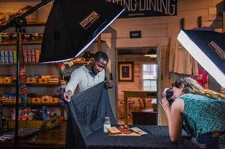 Chad Hunter assisting in a product photo shoot for a locally sourced item in the general store