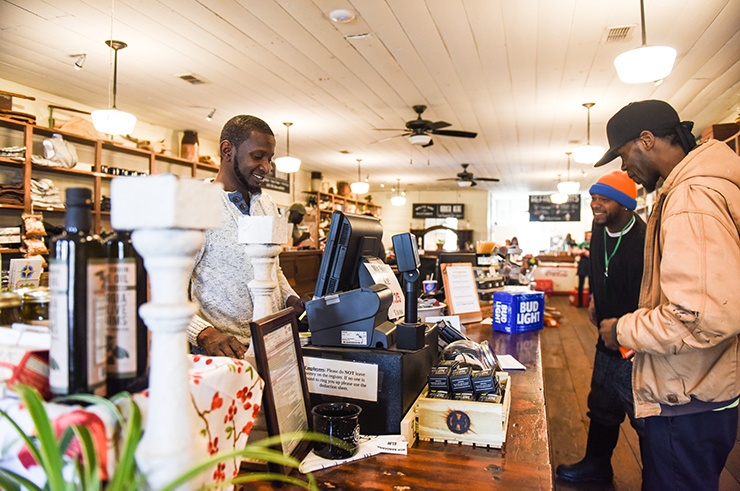 Chad cashing out orders for two employee customers