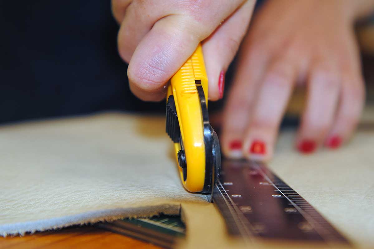 White Oak Pastures cutting leather by hand