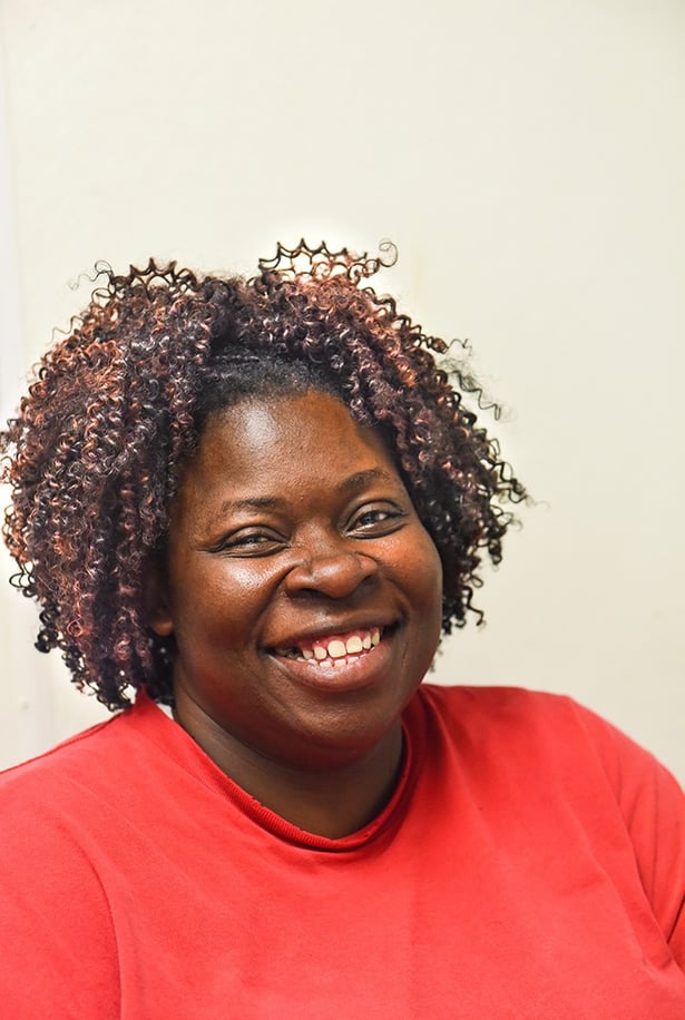 White Oak Pastures Poultry Plant Supervisor and Mentor Helaine smiles at her desk.