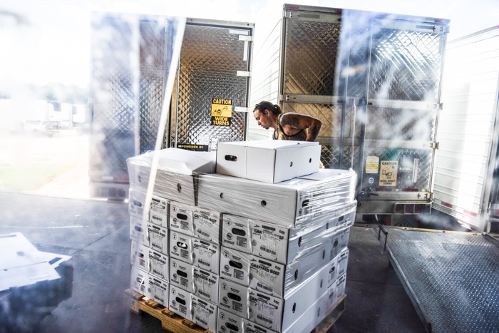 Bubba wraps a palette of ground beef on the loading dock