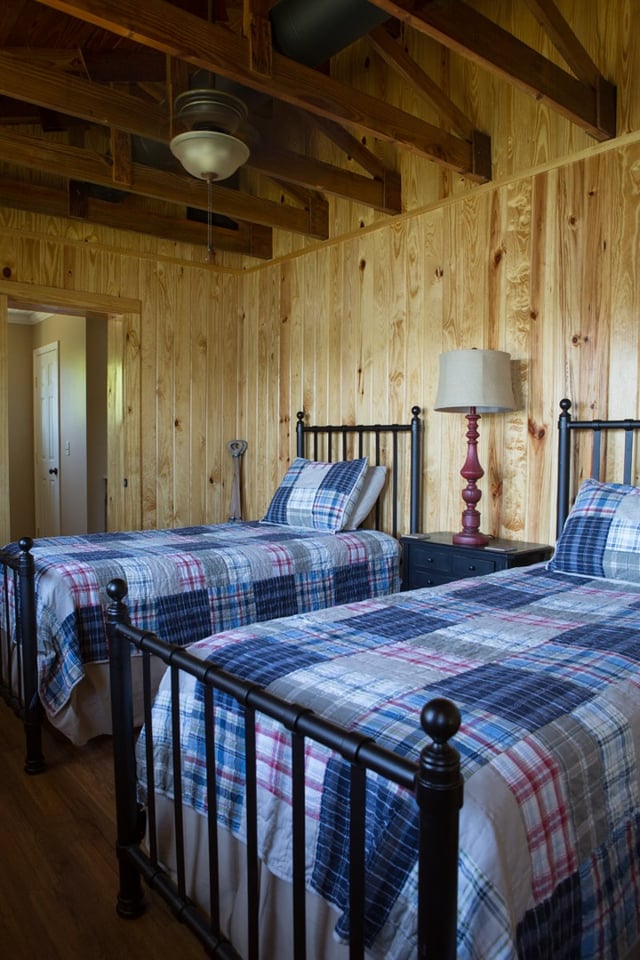 Pond house room 2 with two twin beds and plaid comforters.