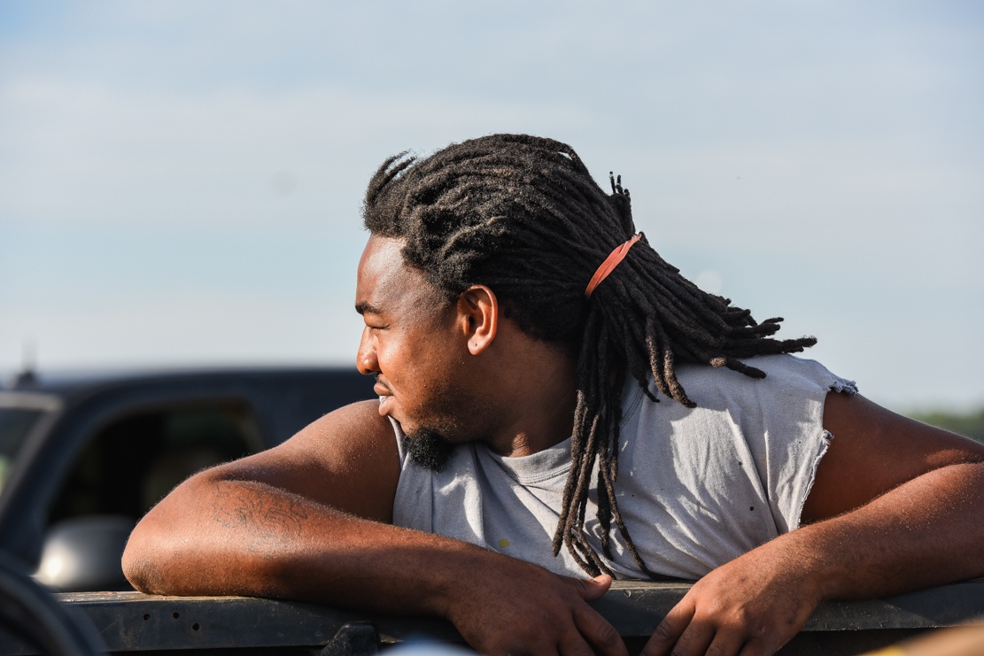 quan takes a break from feeding minerals to the cattle