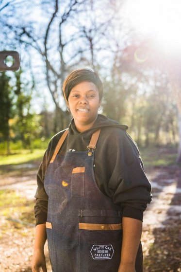 Lashona Butler stands next to the new food truck in Bluffton GA which serves White Oak Pastures pasture raised protein.jpg